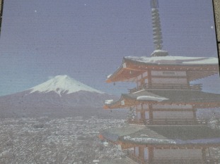 painting on a road "tile" showing how it could look during the winter when Mt Fuji is visible